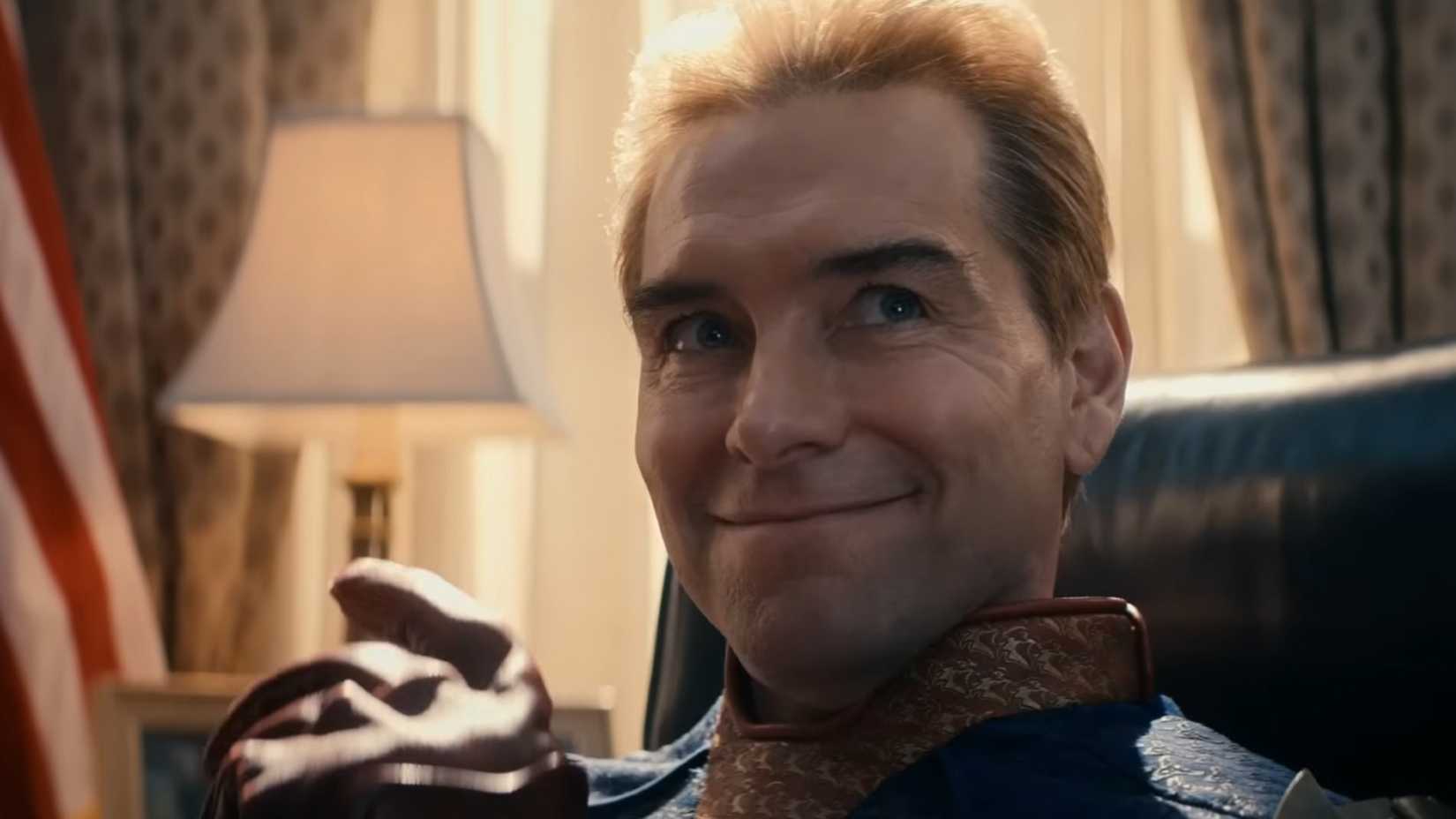 homelander smiles while sitting at the resolute desk in the oval office in the boys season 4 2