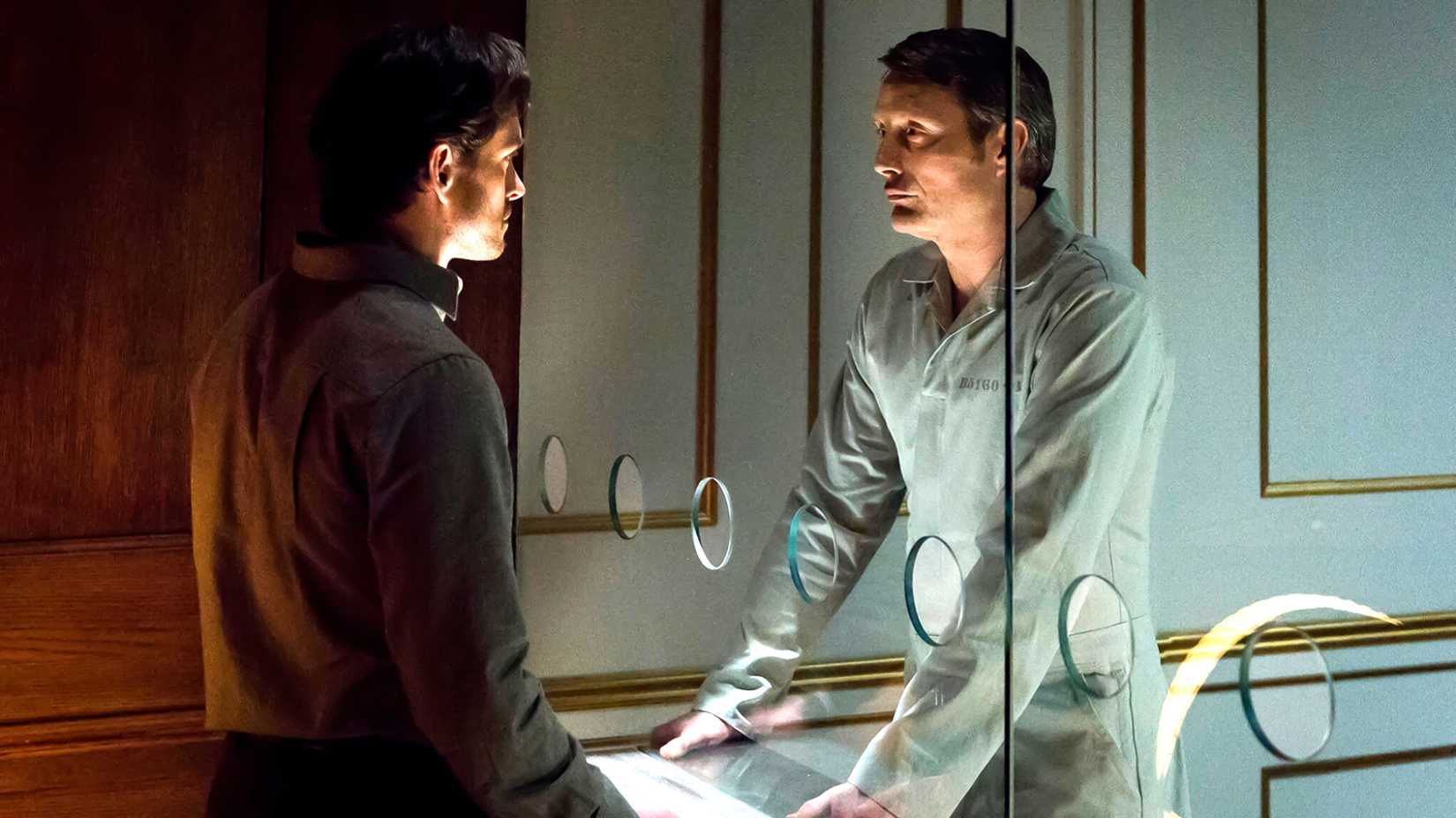 Don't Give Up On Hannibal Season 4 Just Yet 2 Hugh Dancy's Will looking at Mads Mikkelsen's Hannibal through a plexiglass prison wall in Hannibal