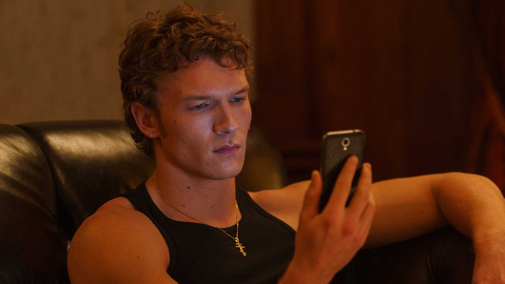 ilya rozanov looks at his phone in heated rivalry