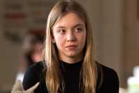 Sydney Sweeney with a half smile in Sharp Objects