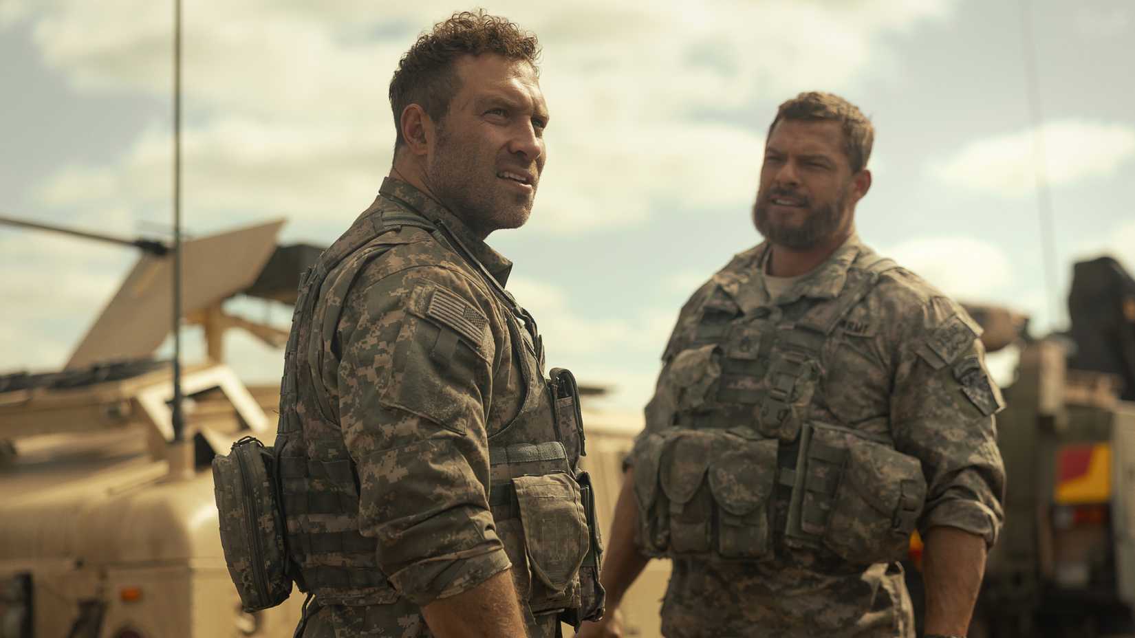 Jai Courtney and Alan Ritchson standing together in army fatigues in War Machine