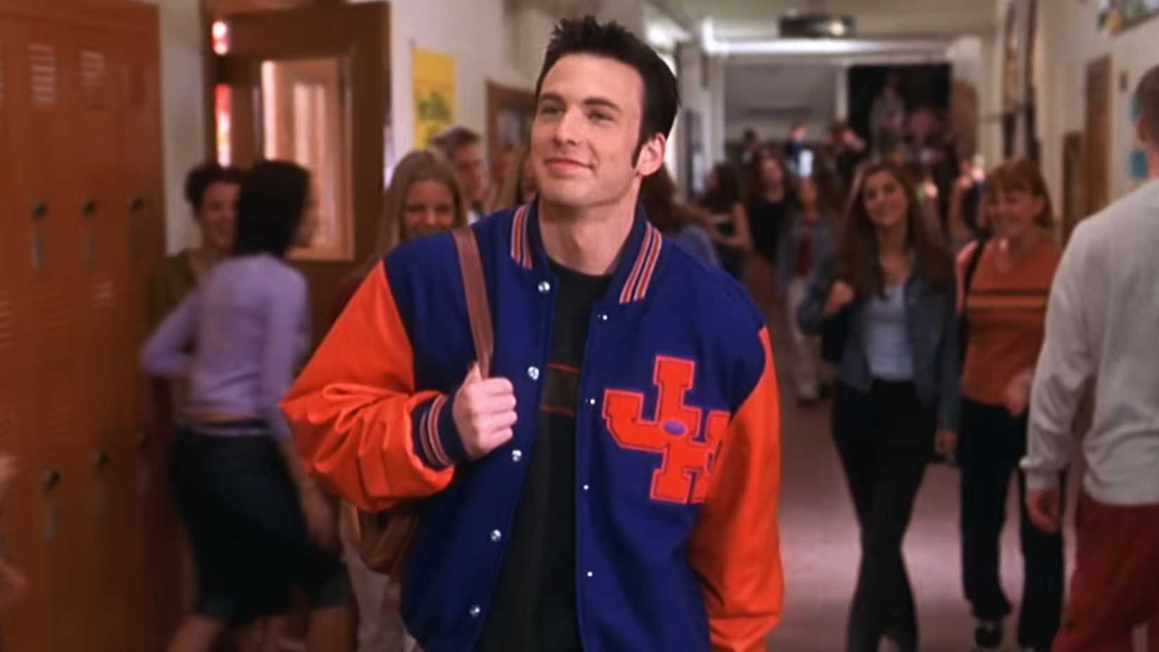Jake strolling down the school hall smiling in Not Another Teen Movie