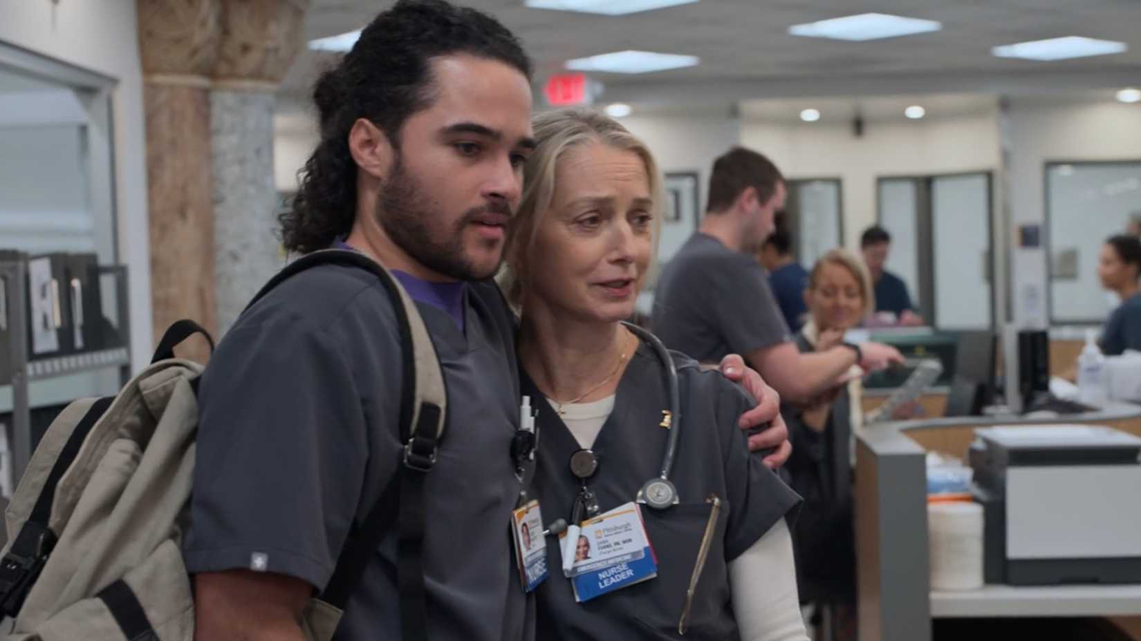 Jalen Thomas Brooks' Mateo hugging Katherine LaNassa's Dana while looking at the board in The Pitt season 2