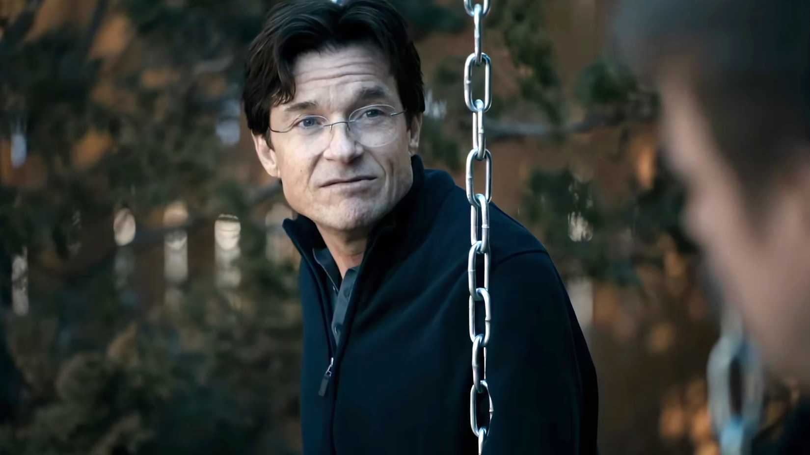 Jason Bateman's Clark looking in thought while sitting on a swing in DTF St. Louis