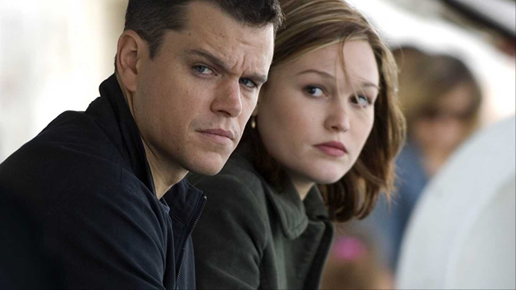 Jason Bourne and Nicky Parsons stare at the camera together in The Bourne Identity