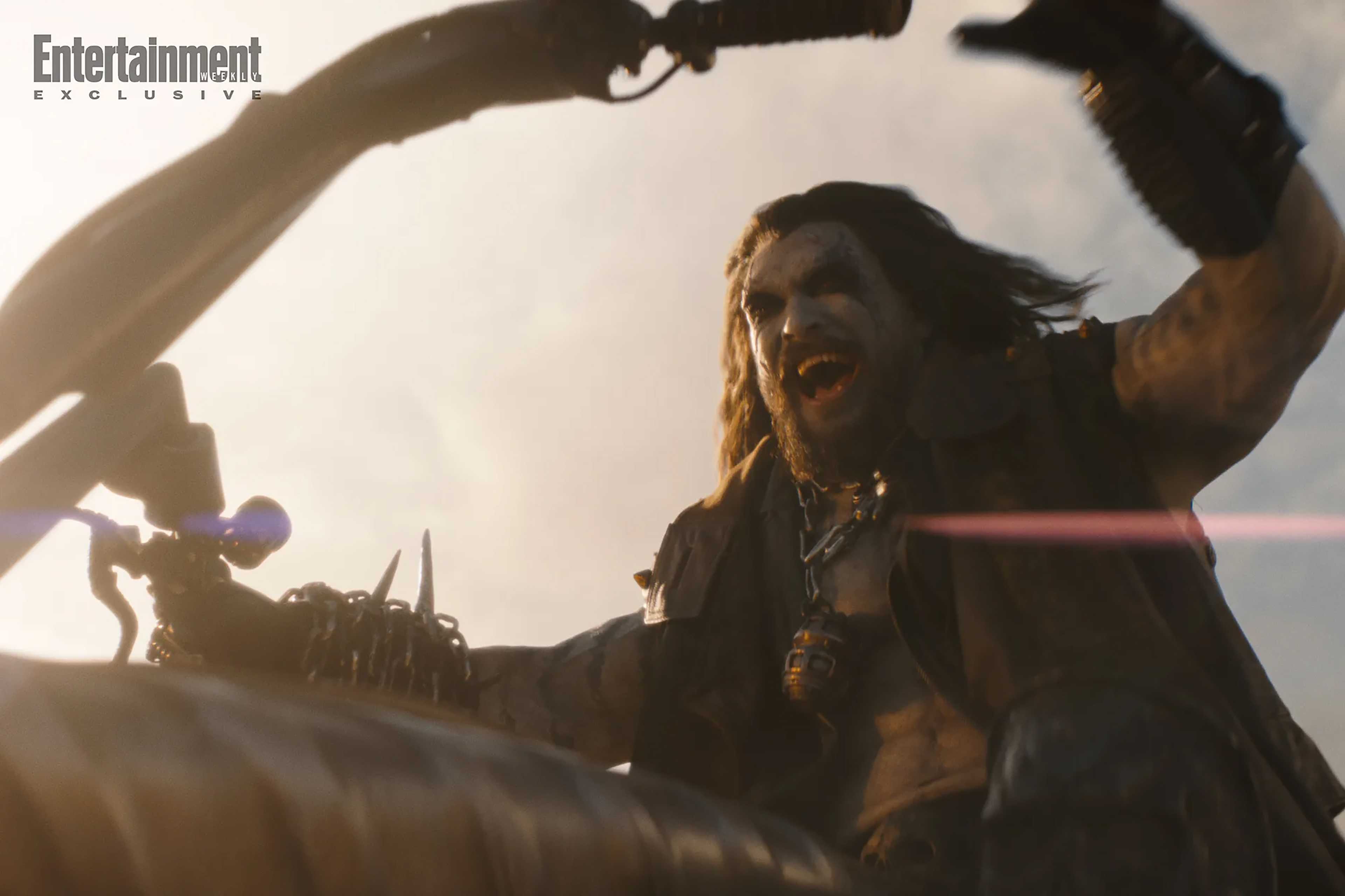 Jason Momoa's Lobo shouting in excitement while on his bike in Supergirl