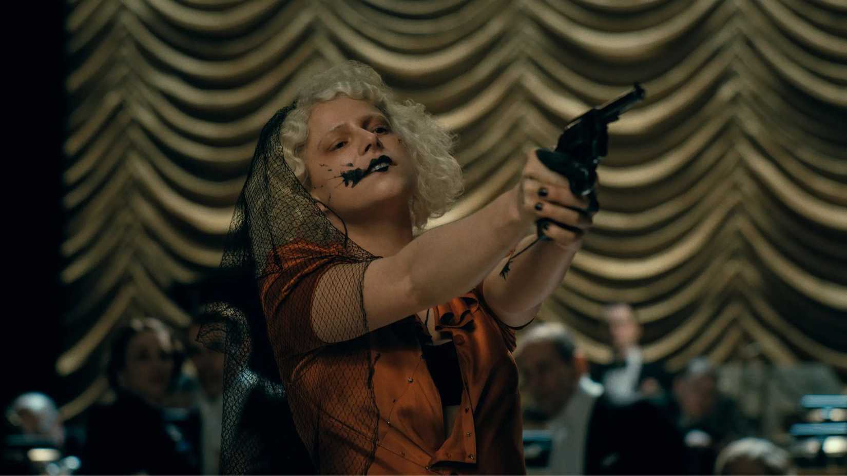 Jessie Buckley with a gun in The Bride