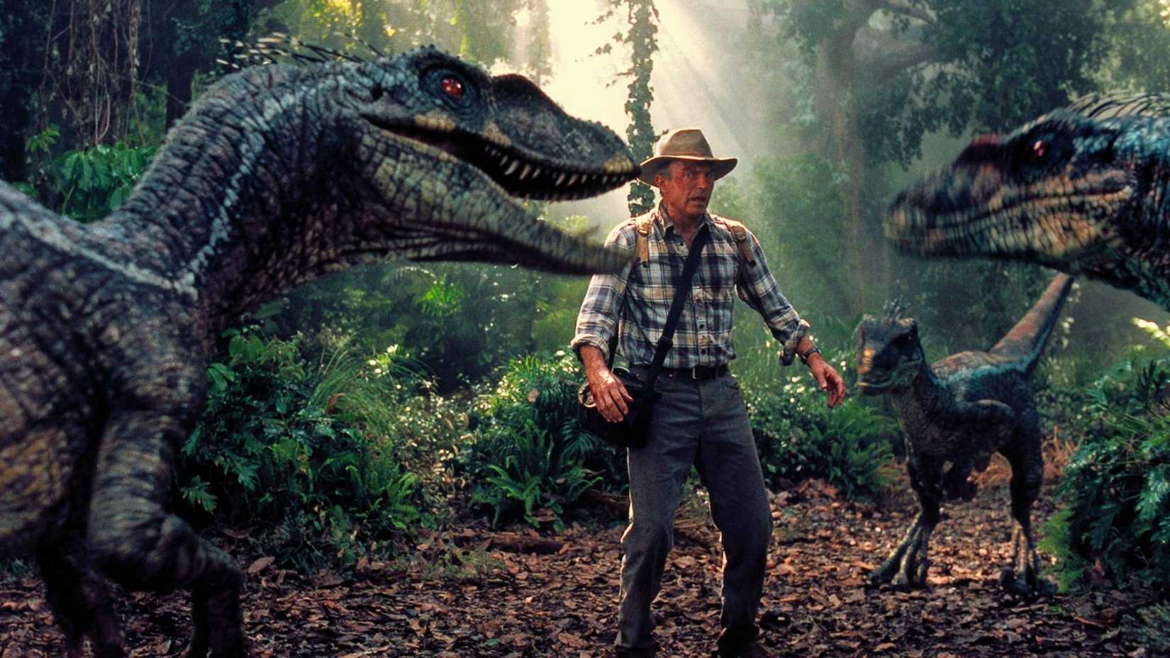 All 7 Jurassic Park Movies In Order, From 1993 To Now 1 Dr. Grant surrounded by raptors in Jurassic Park III