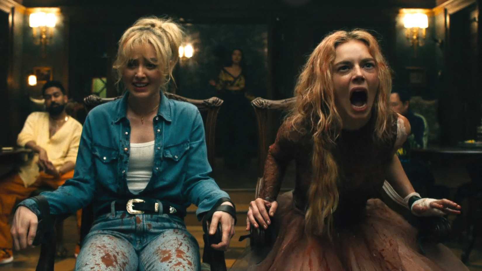 Kathryn Newton e Samara Weaving ensanguentadas e amarradas em cadeiras em Ready or Not 2 Here I Come