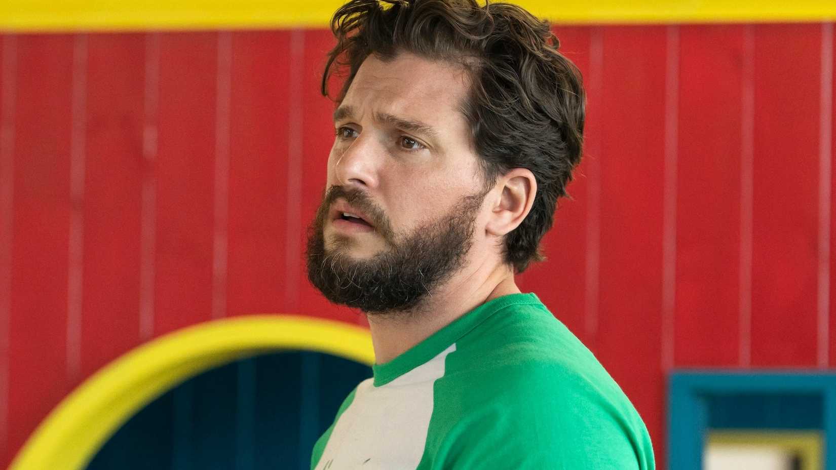 Kit Harington is looking at something in Industry