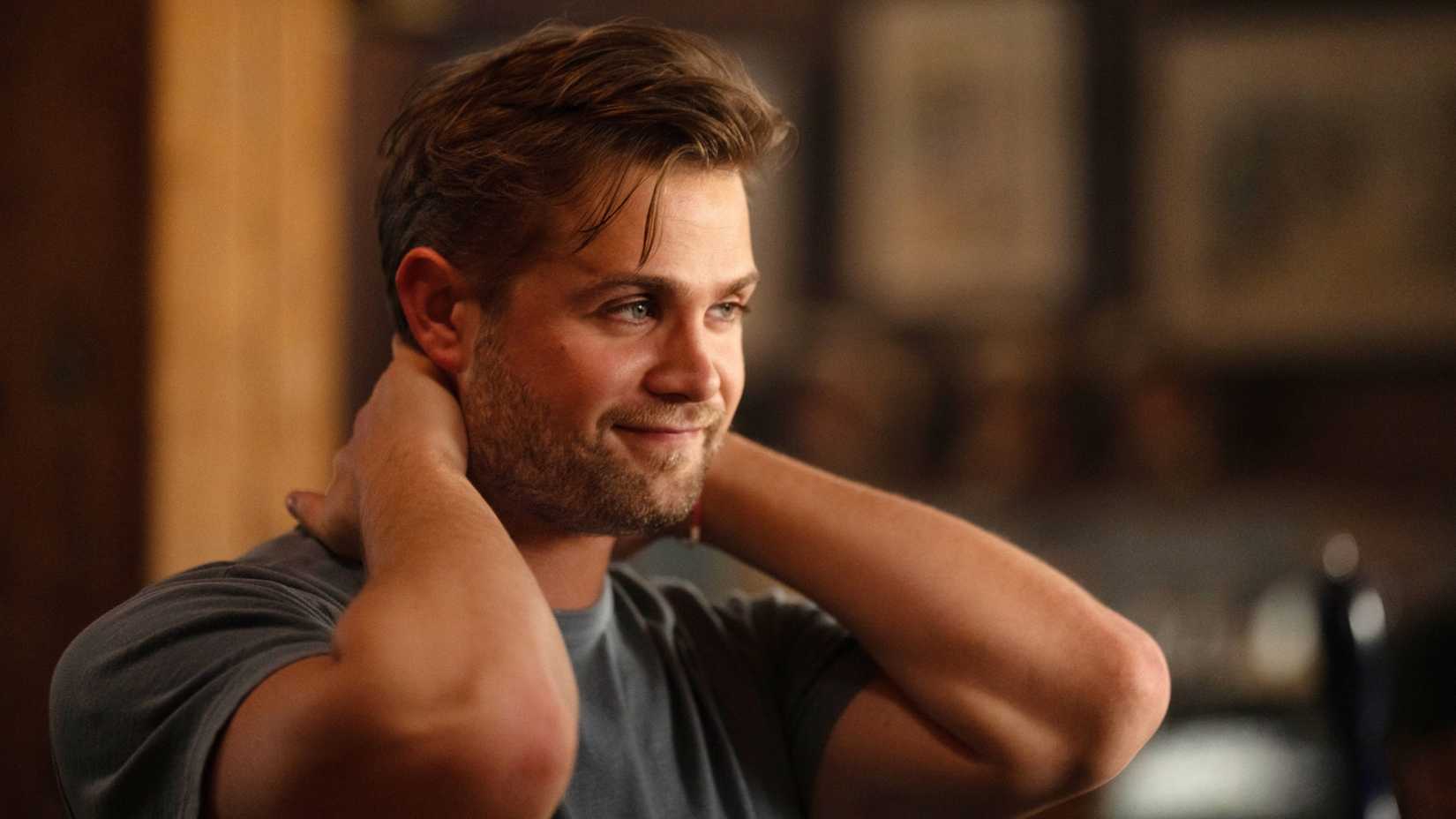 Leo Woodall with his hands on his neck in Vladimir