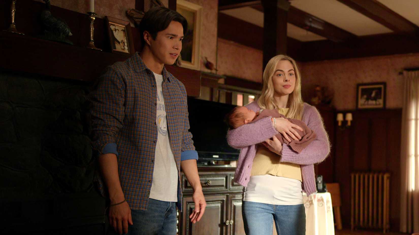 Lizzie holds Koko while standing next to Denny in the living room in Virgin River season 7 episode 6