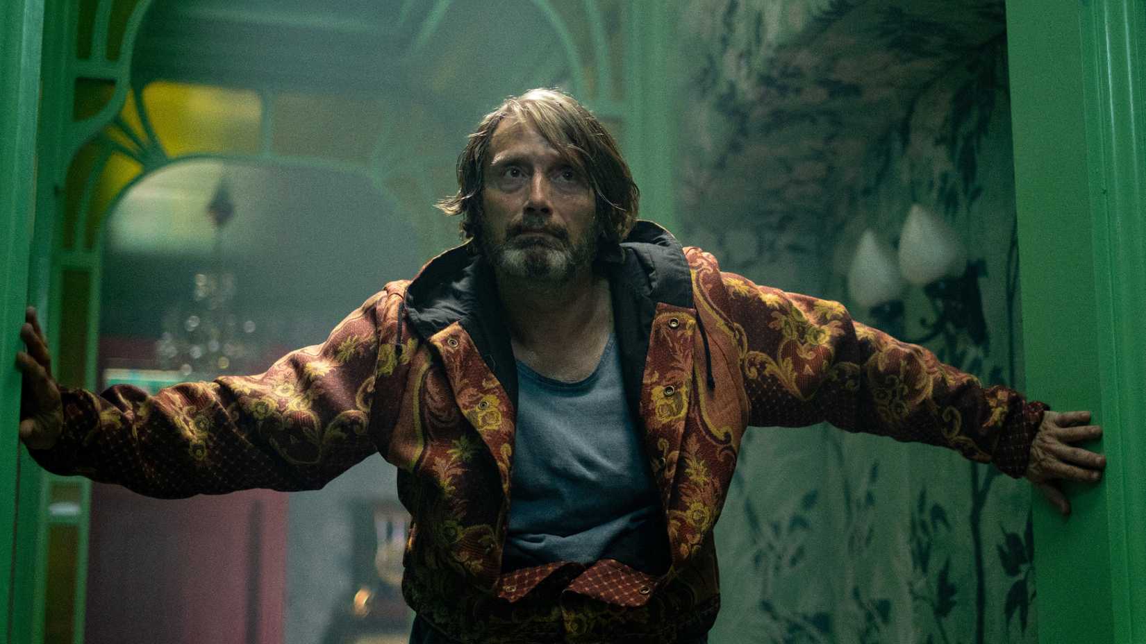 Mads Mikkelsen bracing himself against a corridor in Dust Bunny