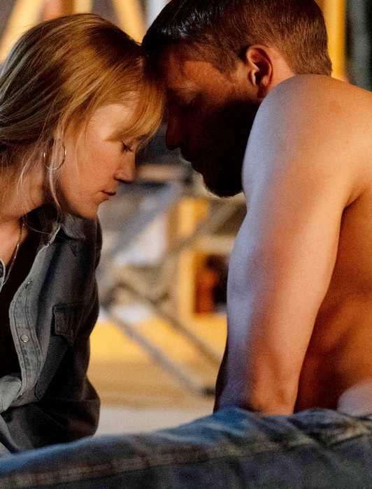 Maika Monroe and a shirtless Tyriq Withers press their heads together in Reminders of Him