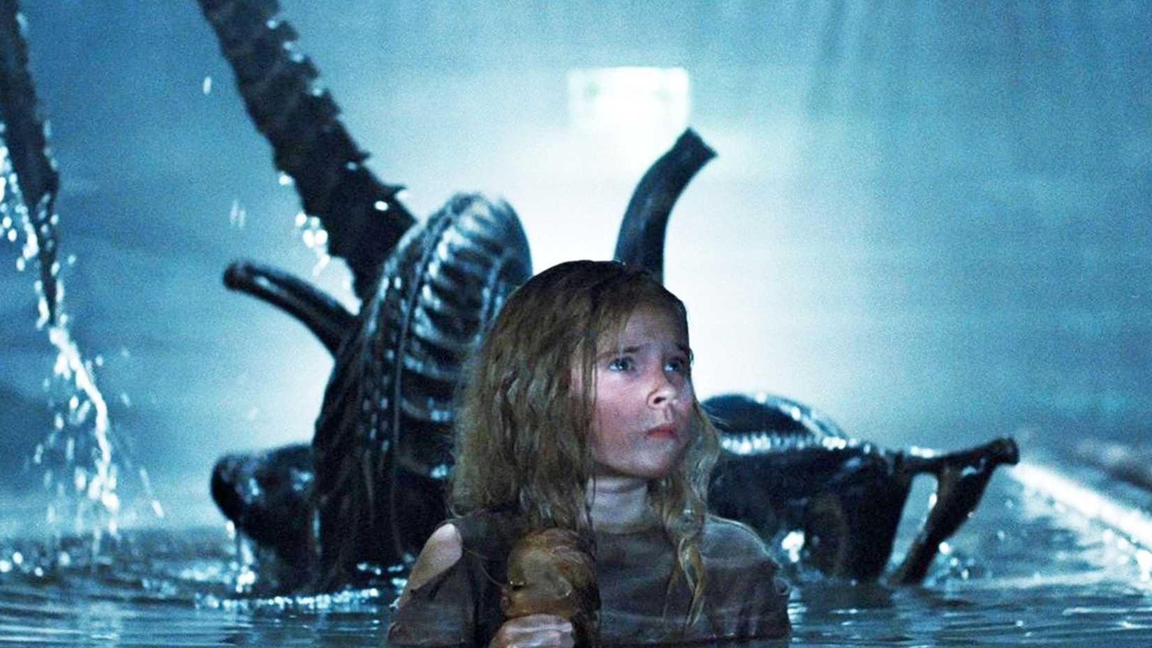 The 7 Smartest Characters In The Alien Franchise, Ranked By Survival Strategy 4 Newt in waist high water while a xenomorph sneaks up on her from behind in Aliens