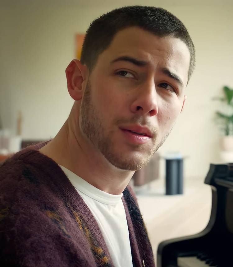Nick Jonas' Danny looking over his shoulder in thought in Power Ballad Vertical