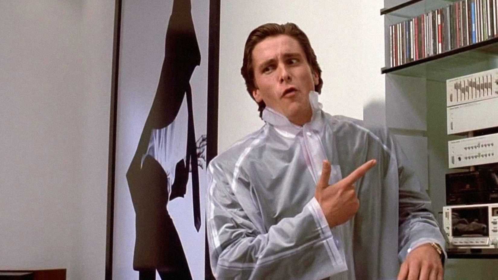 Patrick Bateman (Christian Bale) making a funny face and pointing in American Psycho