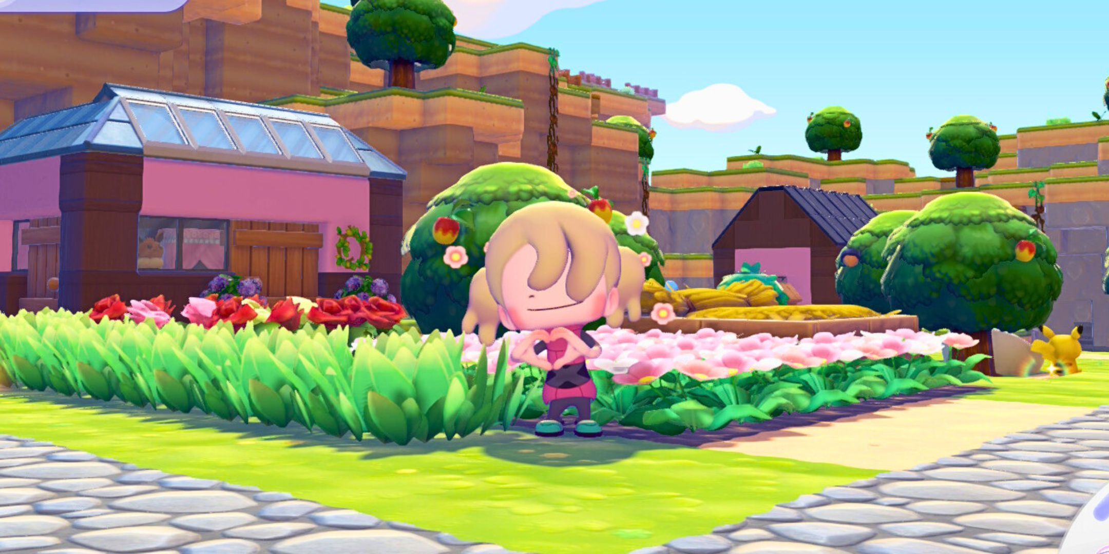 Pokemon Pokopia player making a heart sign with her hands with an emote