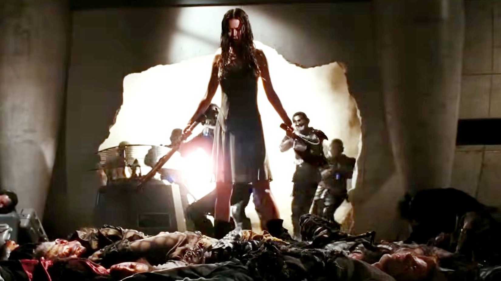 7 Unanswered Questions From Serenity A Firefly Revival Would Need To Finally Answer 4 River (Summer Glau) standing over a pile of reaver bodies with Alliance soldiers in the background from Serenity