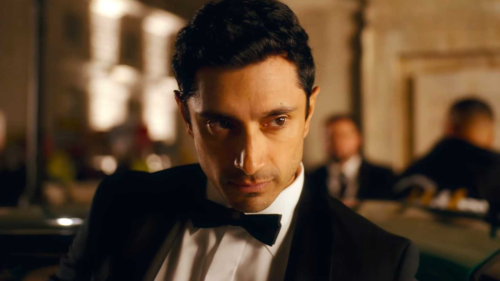 Riz Ahmed's Shah looking suavely while stepping out of a car in Bait