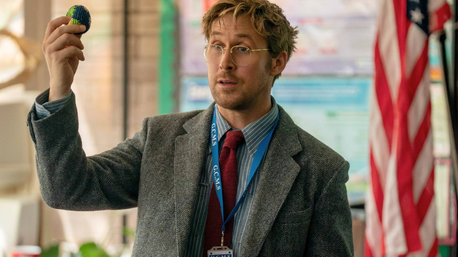 Ryan Gosling as Ryland Grace holding a small object while addressing a class in Project Hail Mary