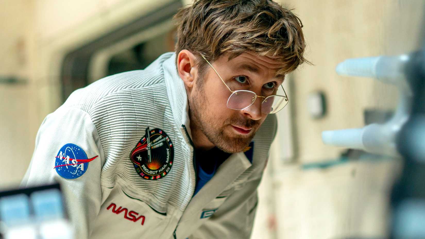 ryan gosling as ryland grace leaning forward in project hail mary