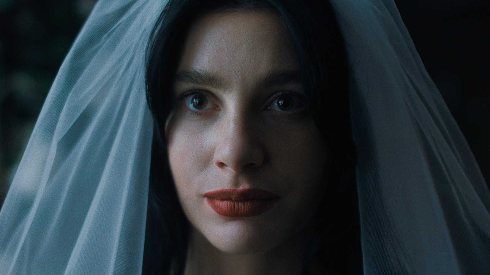 Something Very Bad Is Going To Happen Ending Explained: Does Rachel Survive? 4 Rachel wears a veil while looking worried in Something Very Bad Is Going To Happen