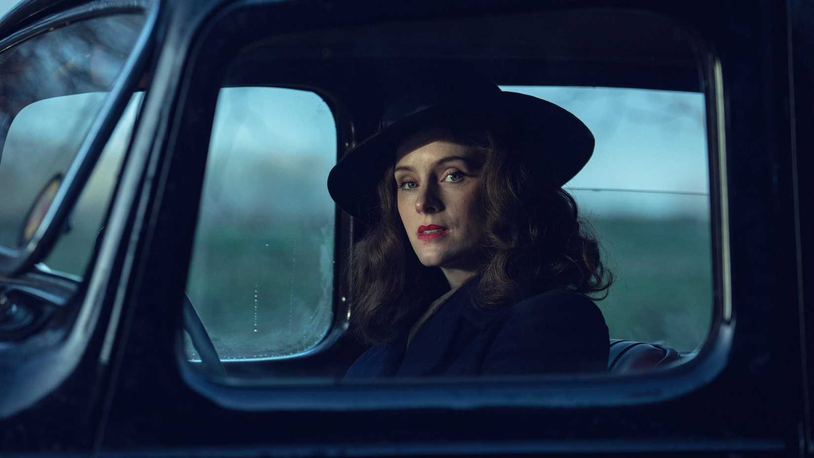 Peaky Blinders: The Immortal Man Ending Explained 2 Sophie Rundle as Ada Shelby driving a car and looking out the window in Peaky Blinders: The Immortal Man