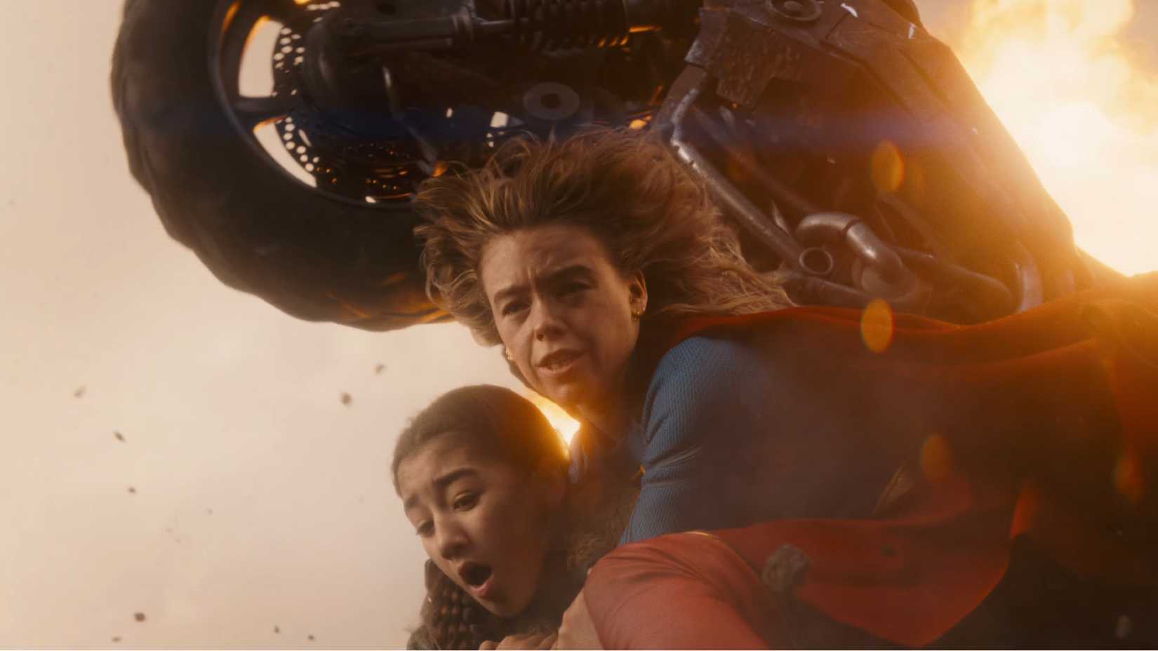 Supergirl saves someone from an explosion in the DC trailer
