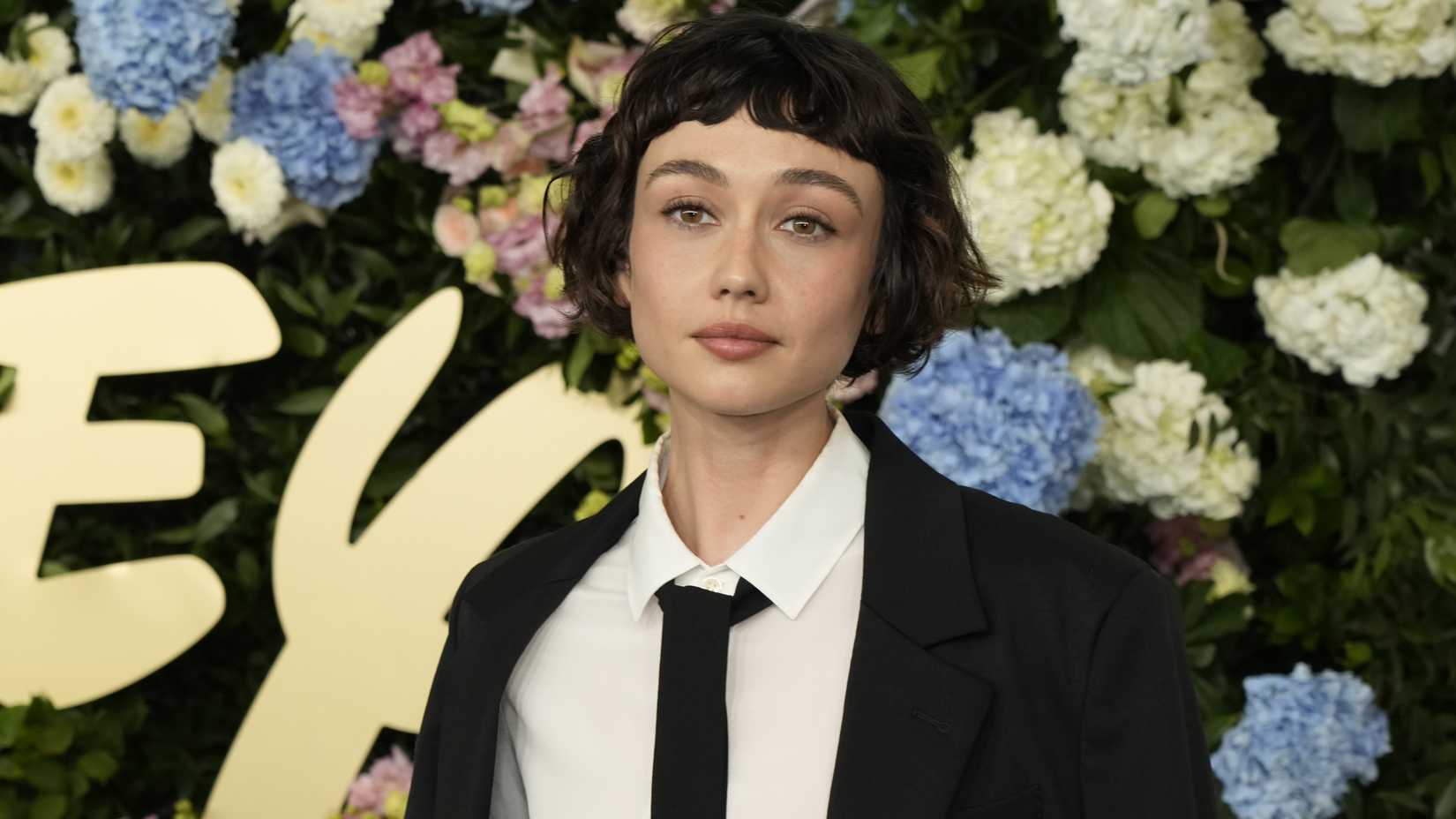 sydney chandler posing for a photo on the 2025 disney upfront red carpet