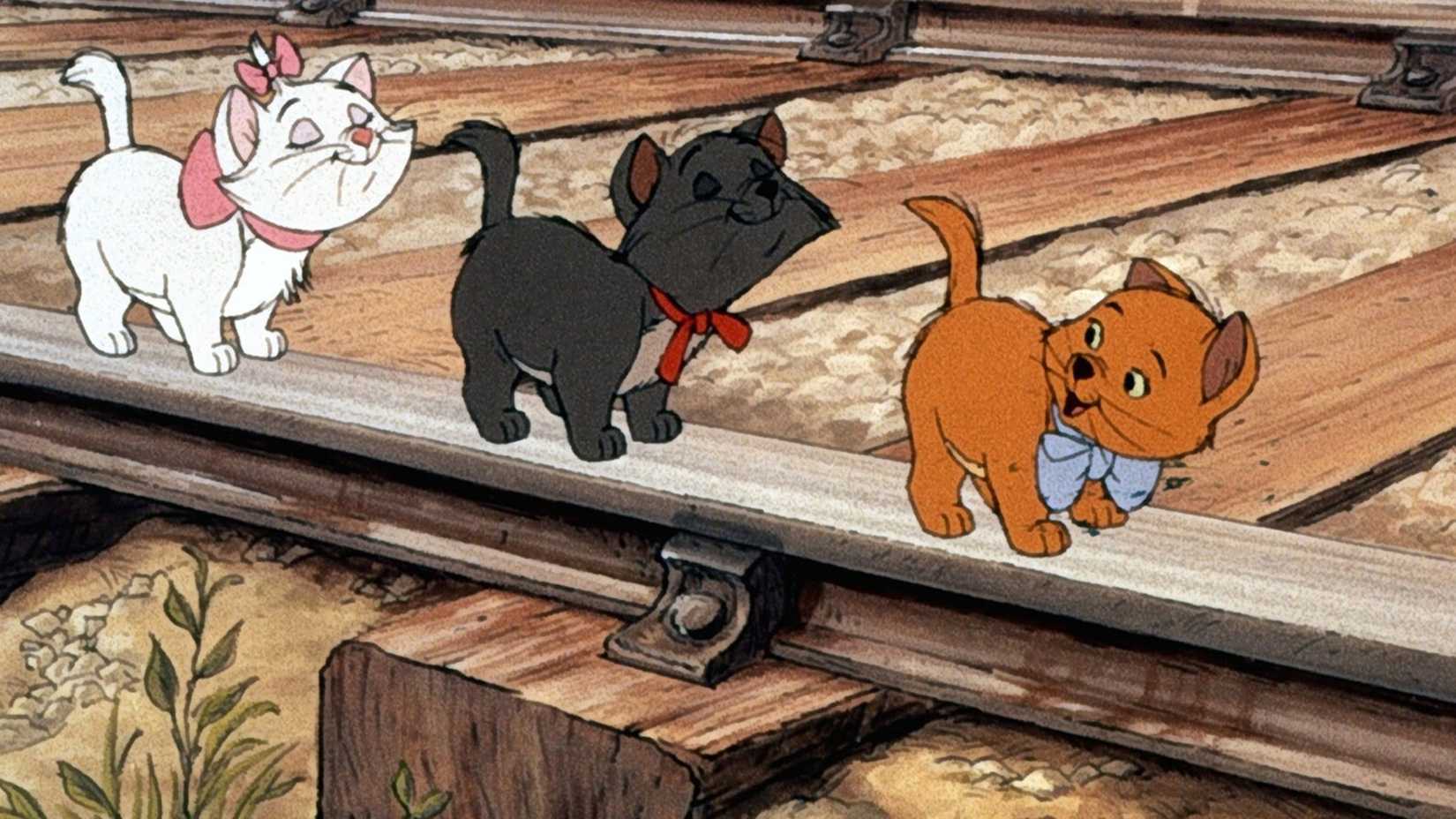 Gatos brincam em um trilho de trem em As Aventuras de Gato