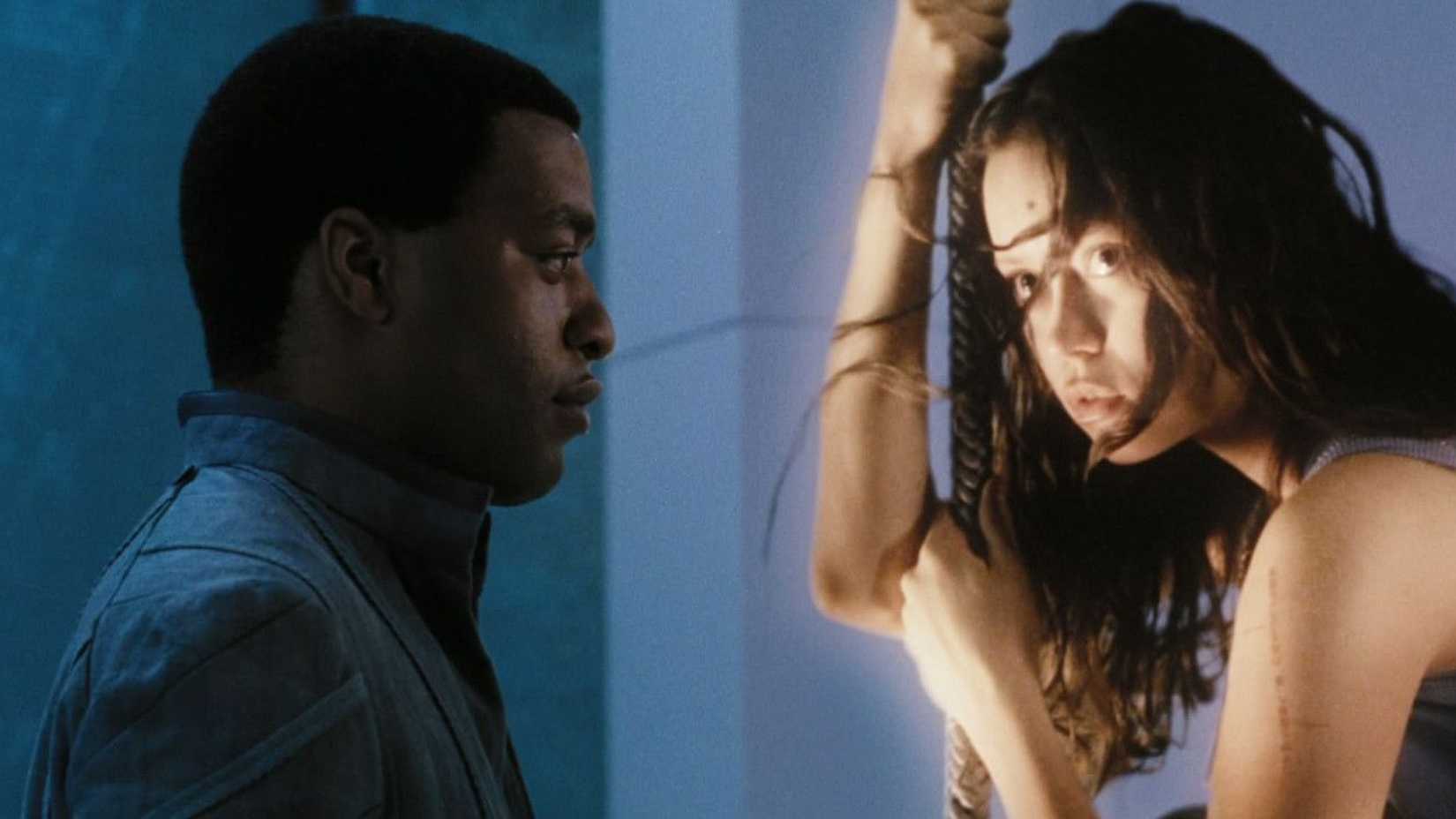 7 Unanswered Questions From Serenity A Firefly Revival Would Need To Finally Answer 1 The operative looking at a hologram of River Tam in Serenity