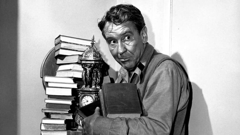 Twilight Zone Episodes With Breathtaking Twists, Surprises, And Themes 5 Romney (Burgess Meredith) holding his books in The Twilight Zone.