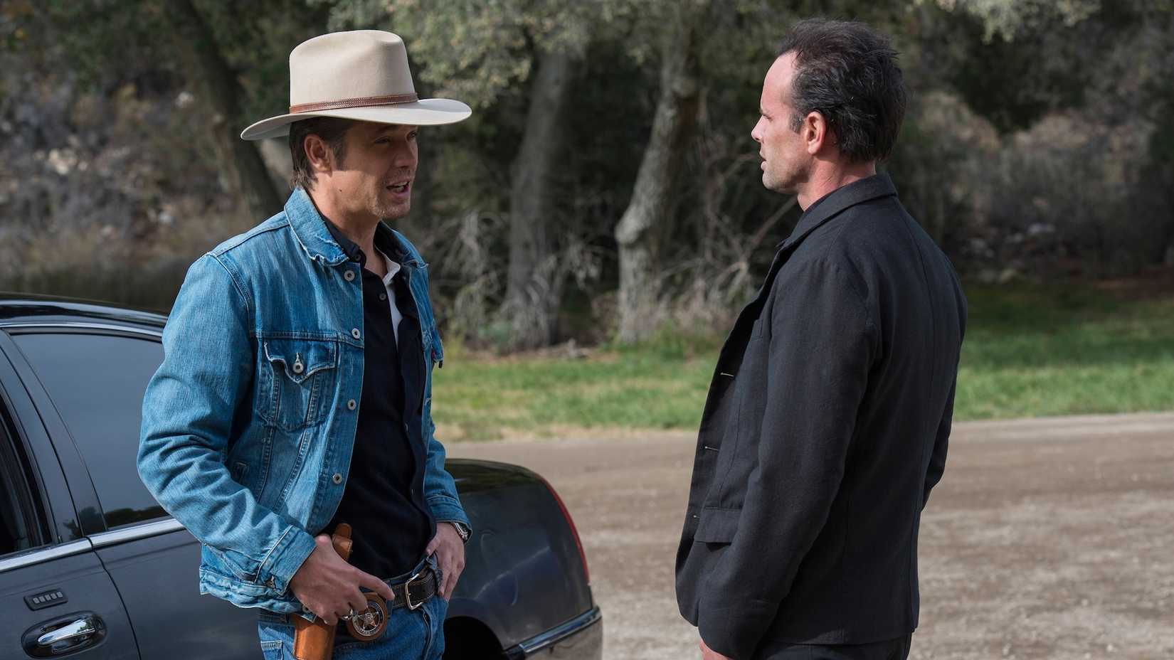 Raylan (Timothy Olyphant) and Boyd (Walton Goggins) talking to one another in Justified City Primeval