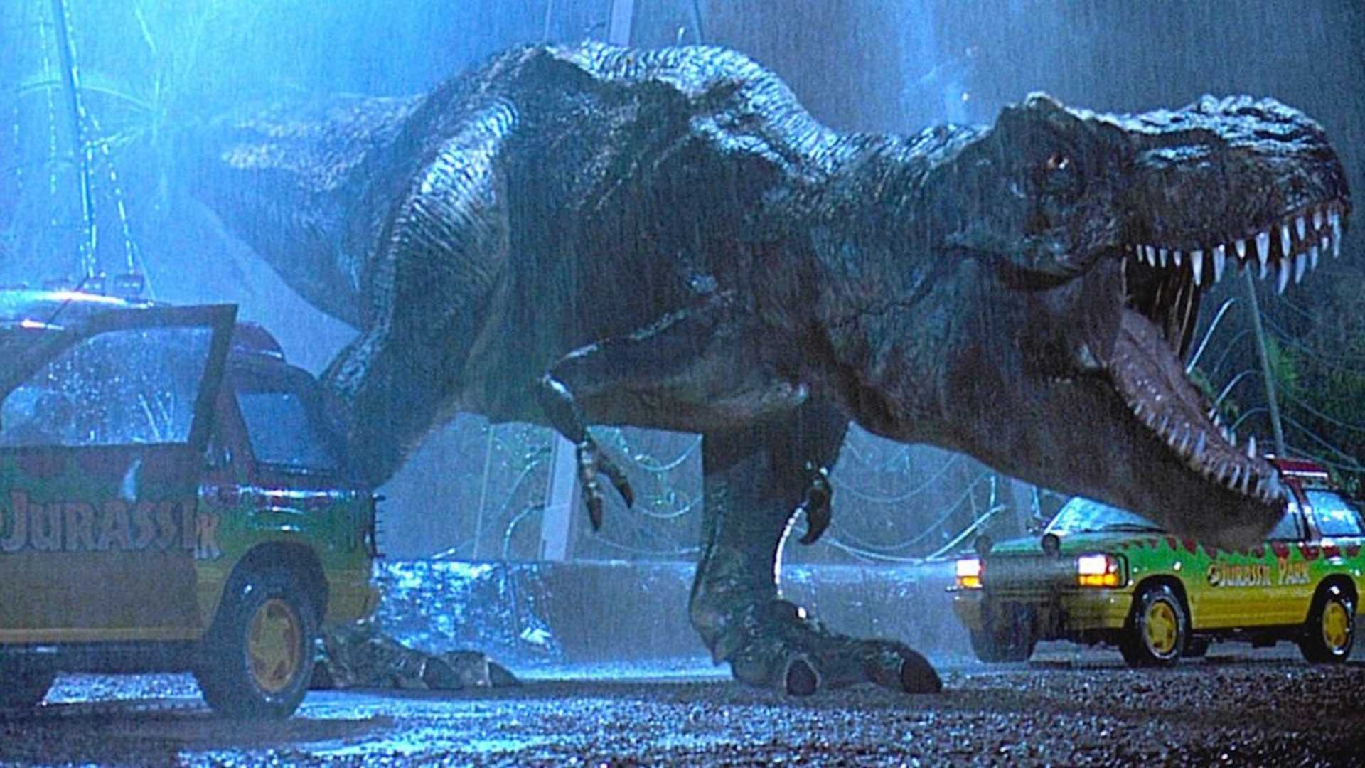 tyrannosaurus escaping its enclosure between two cars in jurassic park