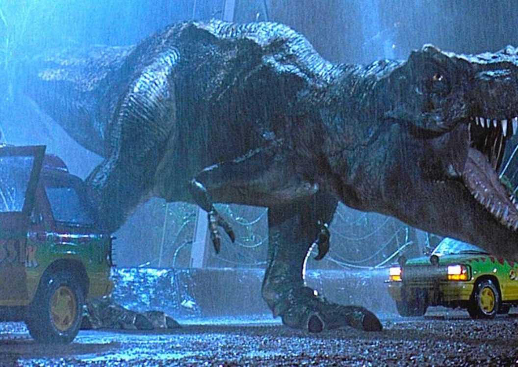 tyrannosaurus escaping its enclosure between two cars in jurassic park
