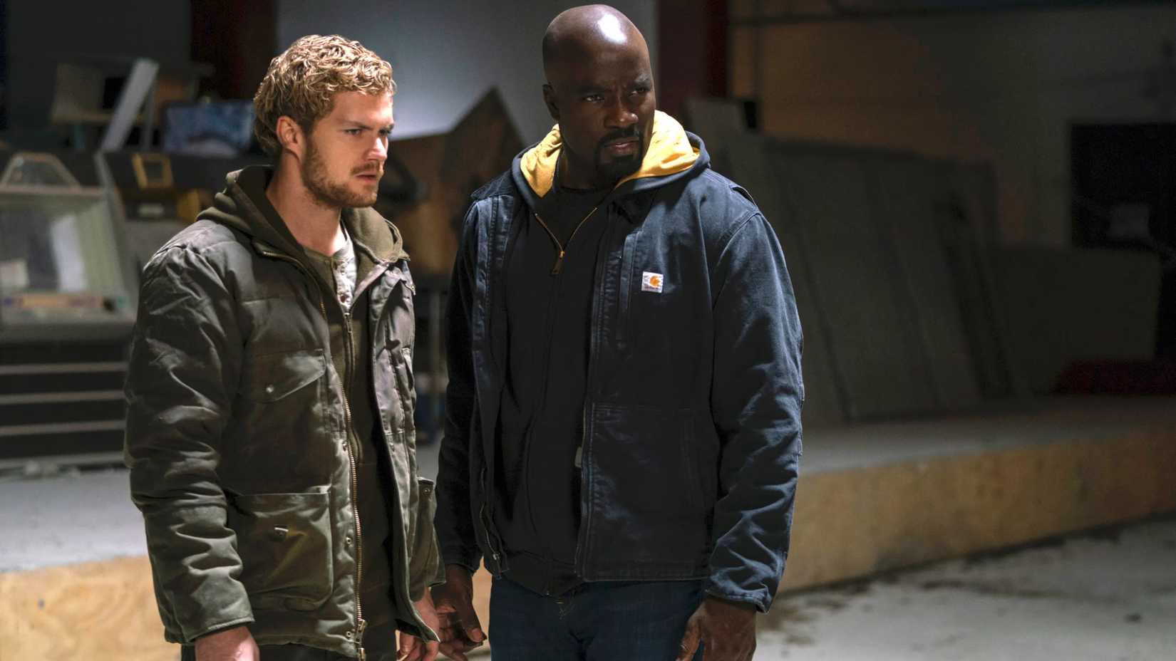 Finn Jones as Iron Fist and Mike Colter as Luke Cage in The Defenders