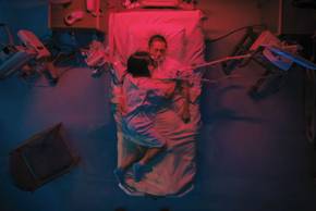Steven Yeun and Ali Wong embraced in a hospital bed in Beef season 1