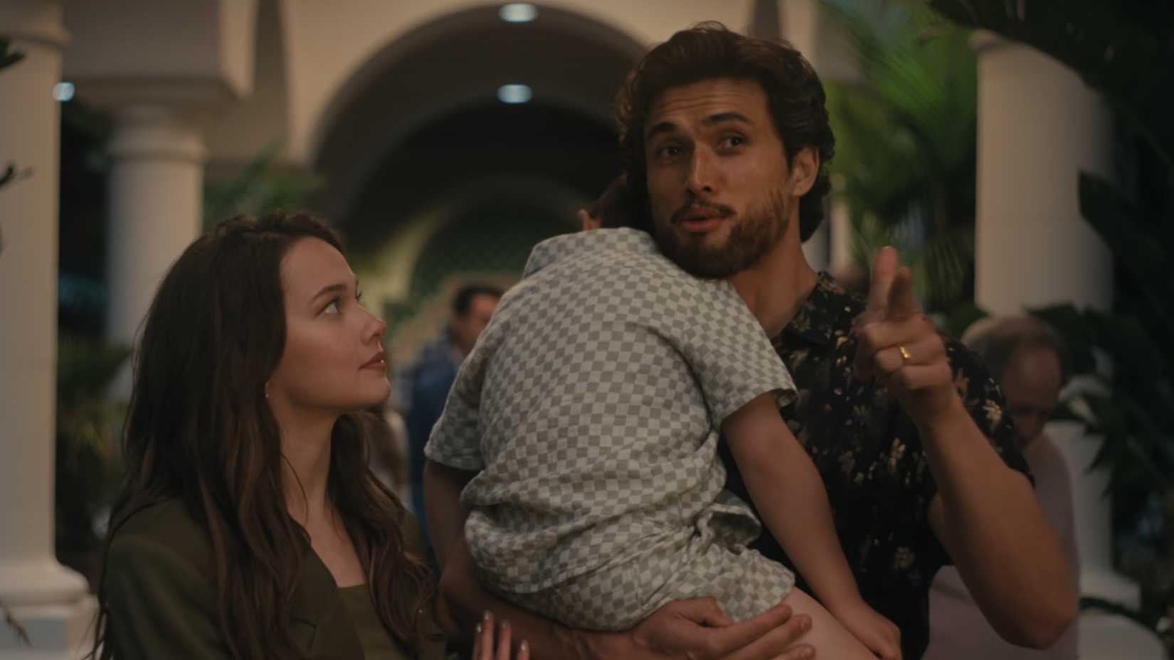 Ashley looks at Austin while he holds their child and points at a character off screen in Beef seaosn 2