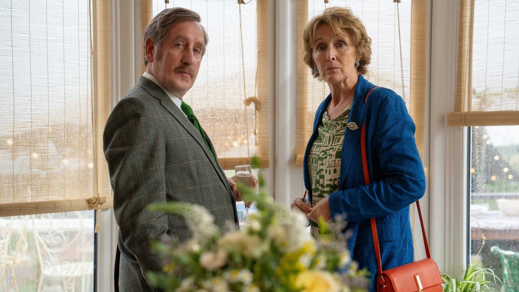 Michael Smiley and Fiona Shaw Looking Towards the Camera in Bad Sisters