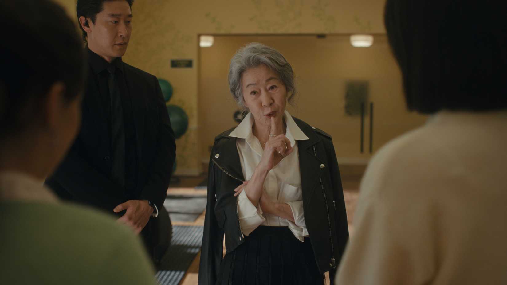 Chairwoman Park holding a finger up to her mouth in Beef season 2