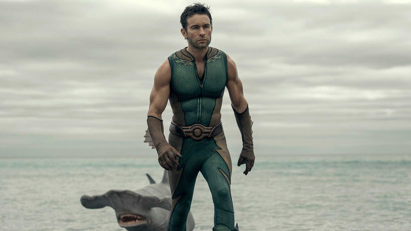 Chace Crawford as The Deep walking from the ocean with a hammerhead shark behind him in The Boys season 5