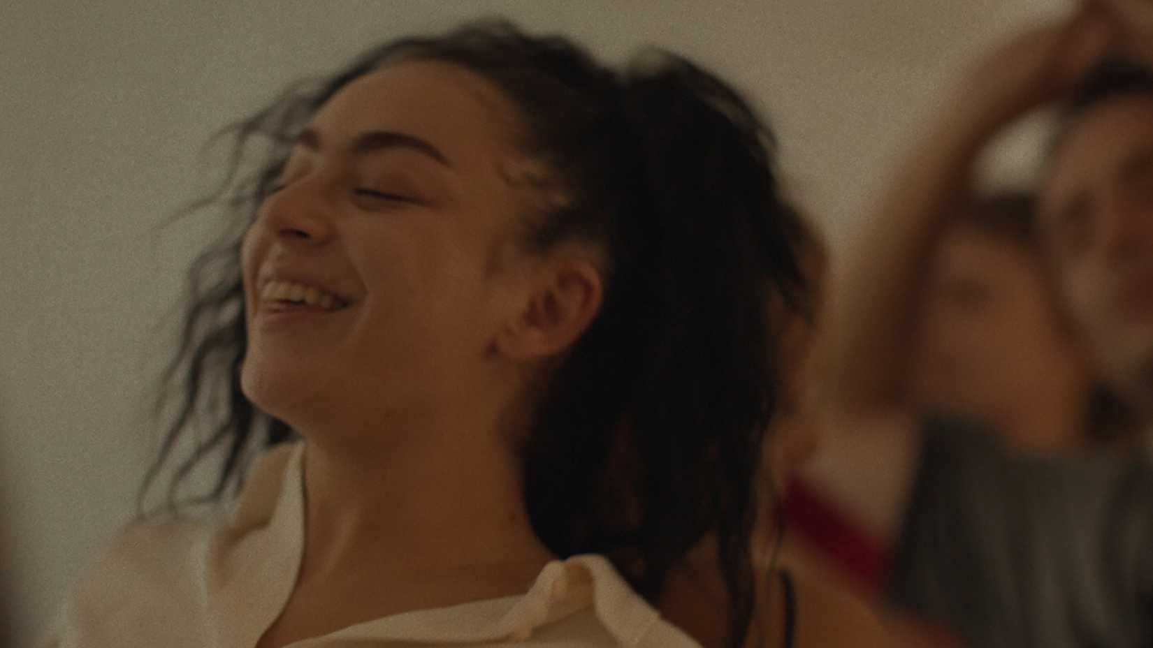 Charli xcx smiling and dancing in Erupcja