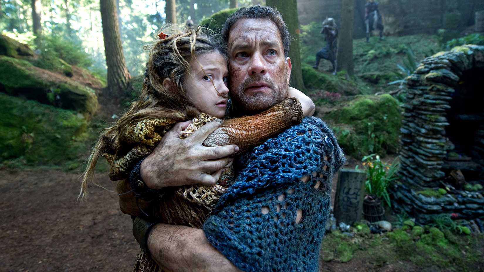 Cloud Atlas' Zachary holding a child and looking worried.