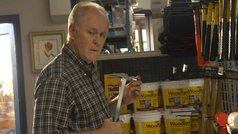 John Lithgow as the Trinity Killer holding a hammer in Dexter season 4