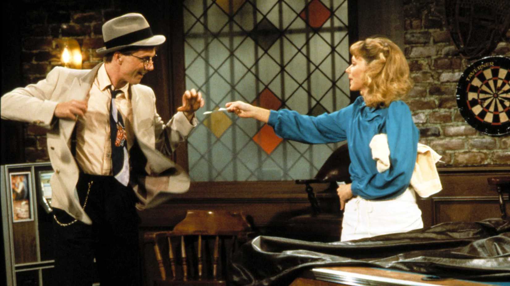 Diane hands something to a conman in Cheers