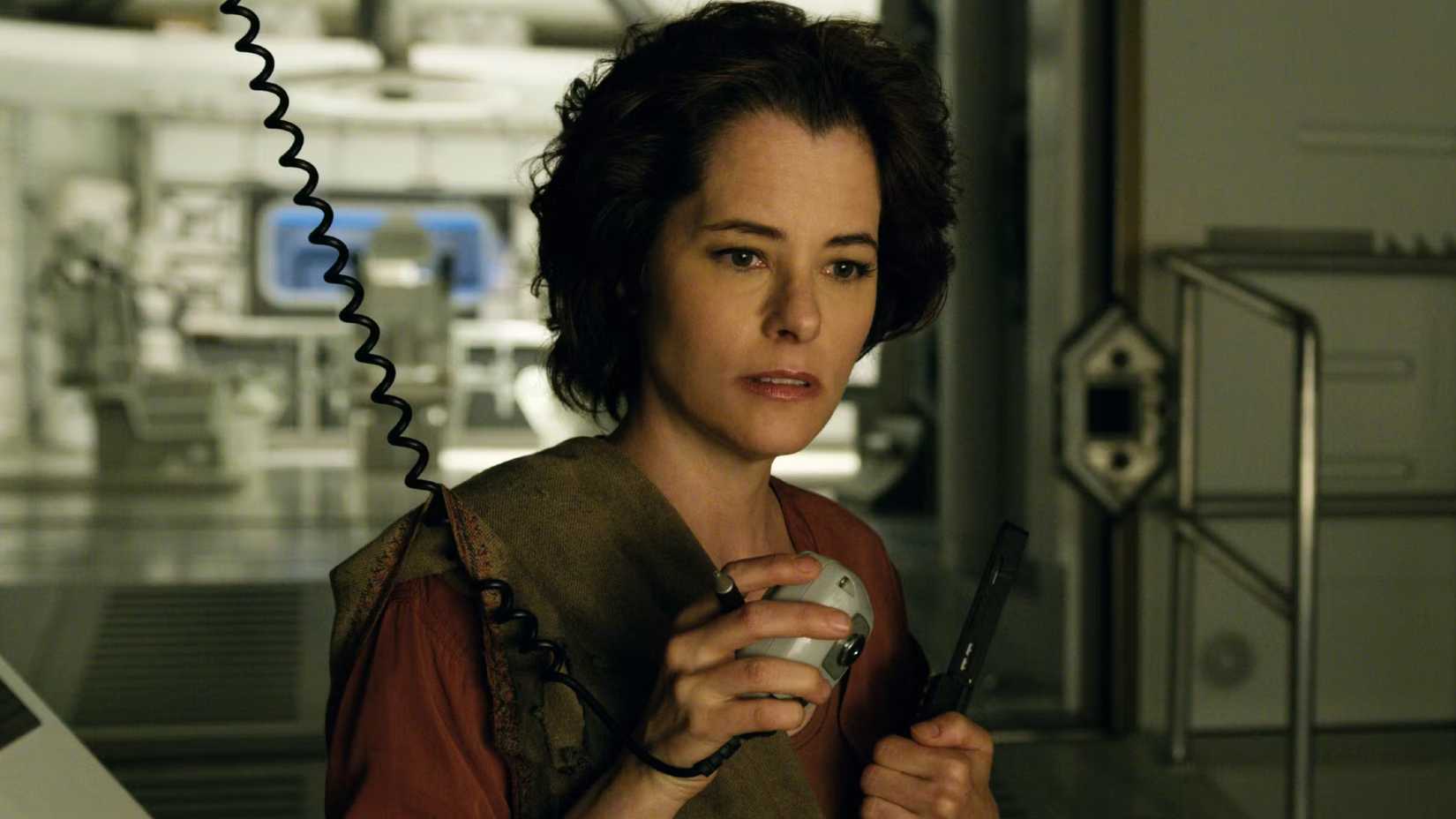 Dr. Smith talks over a walkie talkie in Netflix's Lost in Space reboot