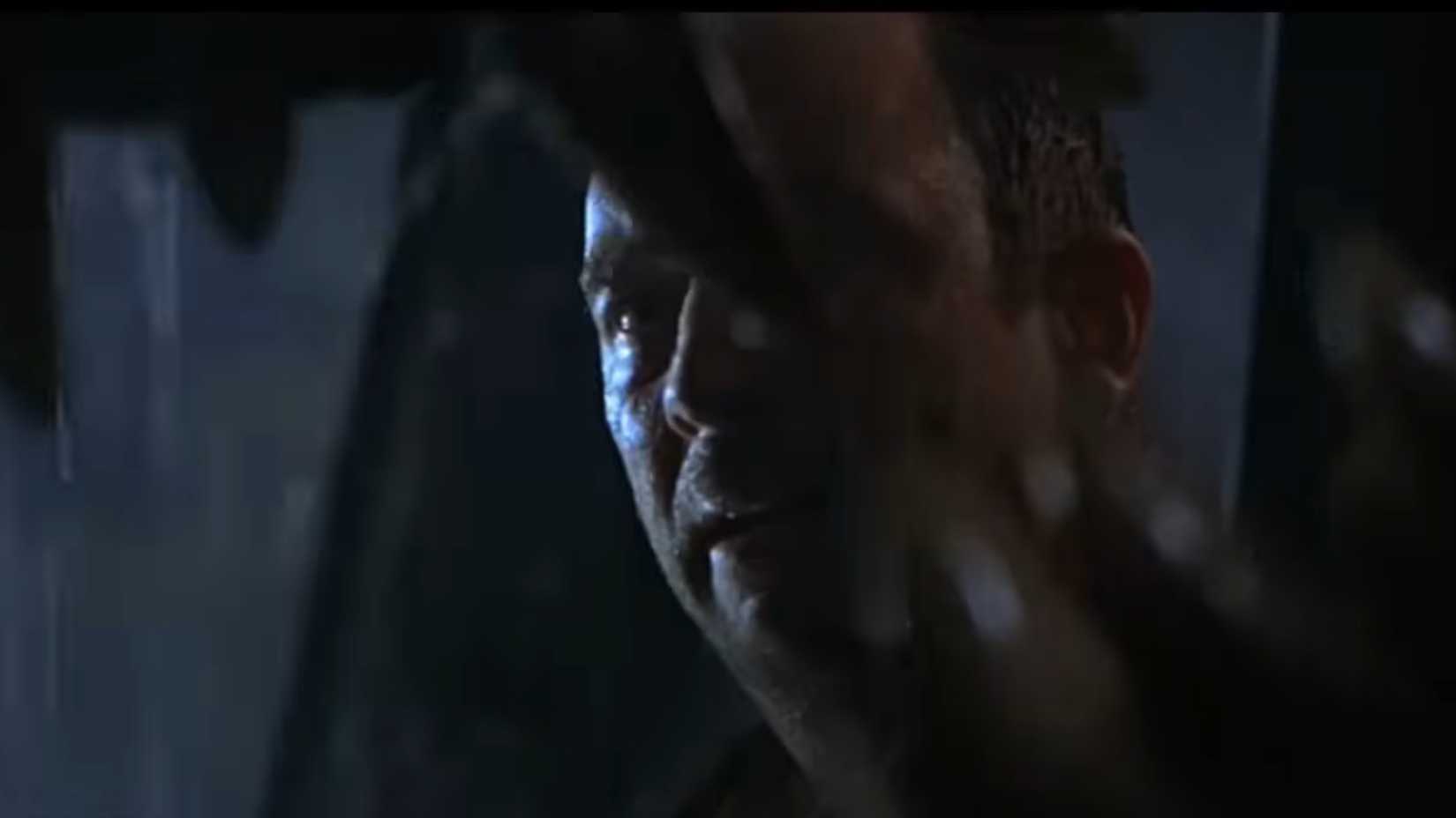 10 Most Shocking Deaths In All 7 Jurassic Park Movies, Ranked 4 Eddie Carr looking at the T rex opening its jaws in The Lost World Jurassic Park