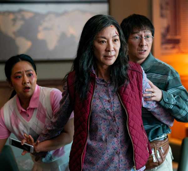 Evelyn Wang puts her arms up in front of Joy and Waymon in Everything Everywhere All at Once.