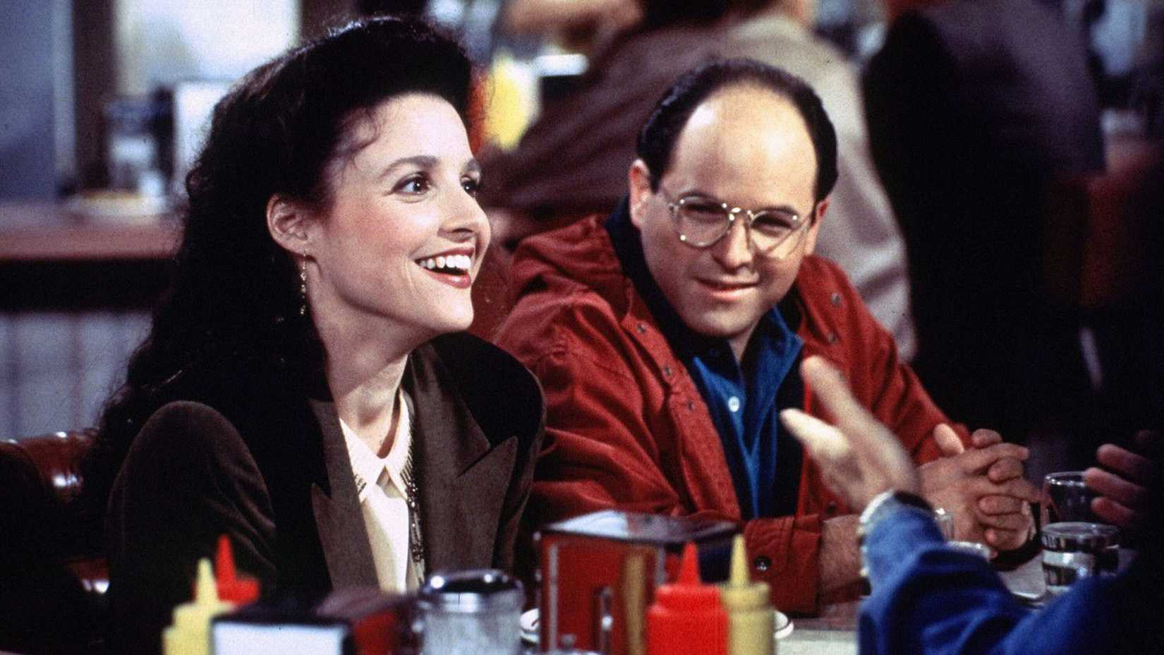 George and Elaine sitting in Monk's Cafe in Seinfeld